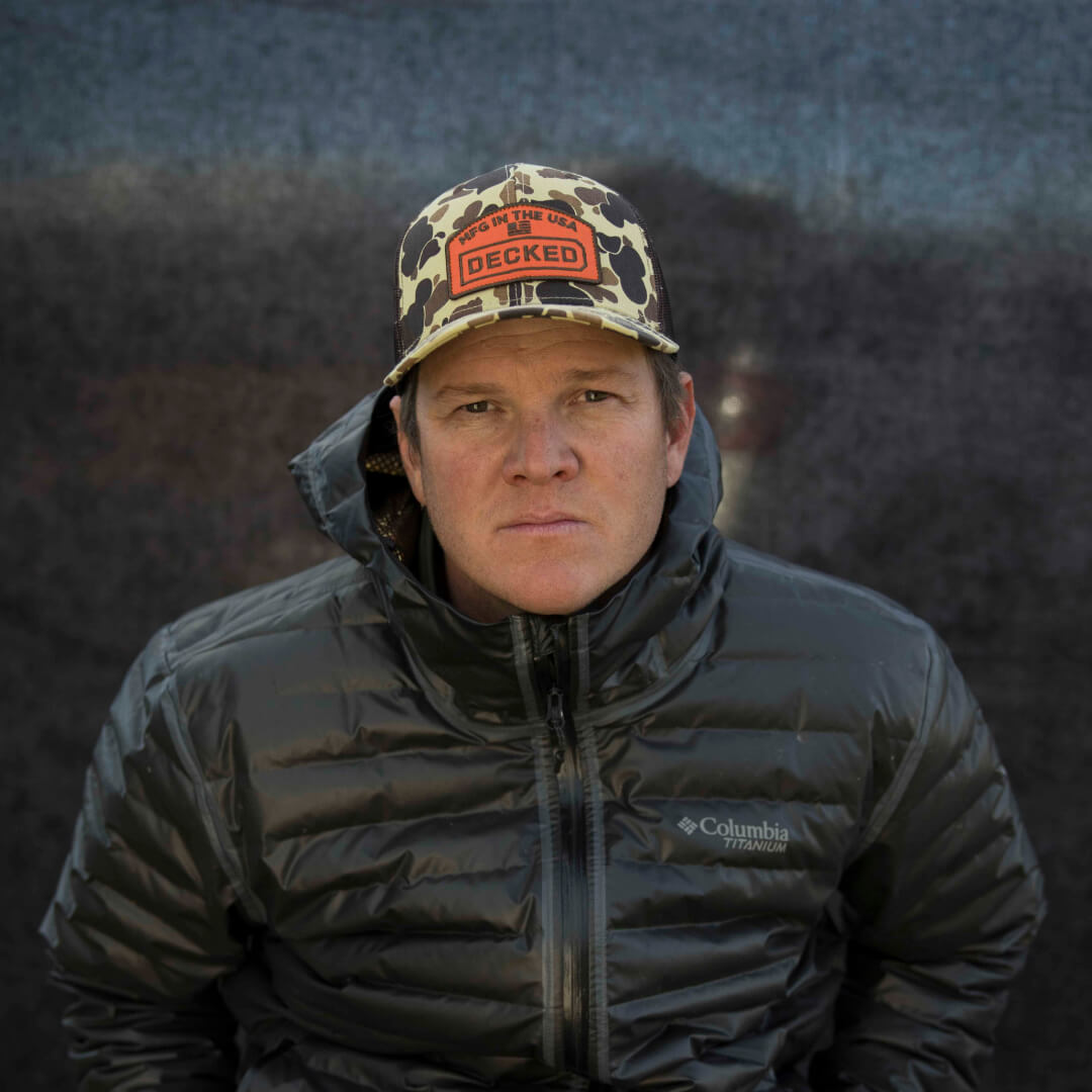 Curtis in a puffy coat and DECKED hat.