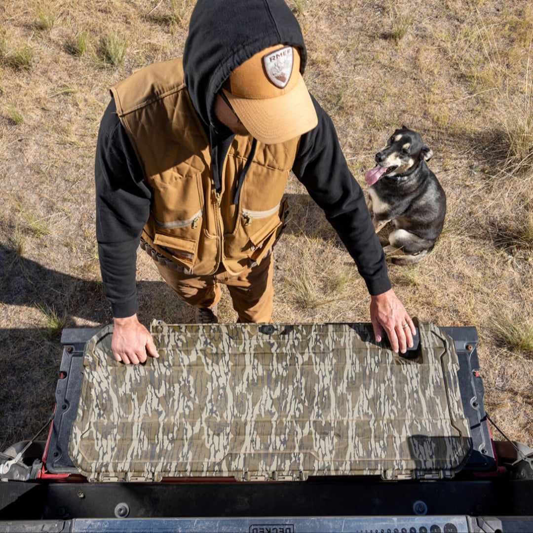 A man grabbing gear out of his DECKED Honcho in Mossy Oak Original Bottomland.