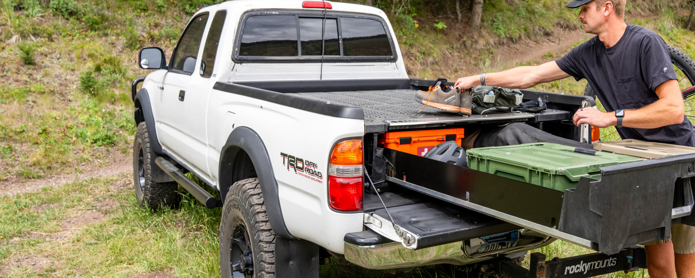 A Gen 1 Toyota Tundra with a Drawer System in the bed filled with mountain biking equiptment.