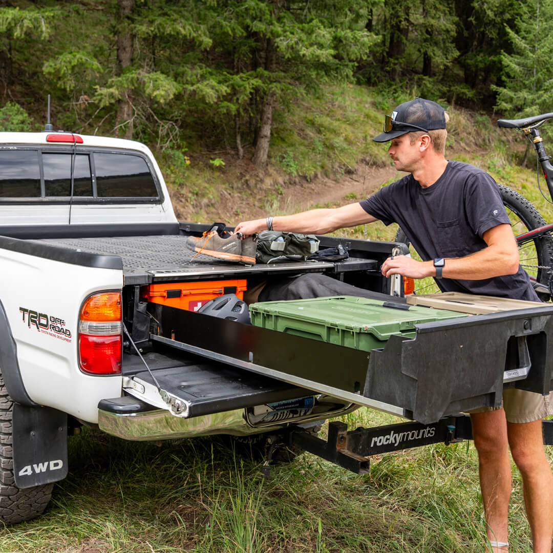 A Gen 1 Toyota Tundra with a Drawer System in the bed filled with mountain biking equiptment.