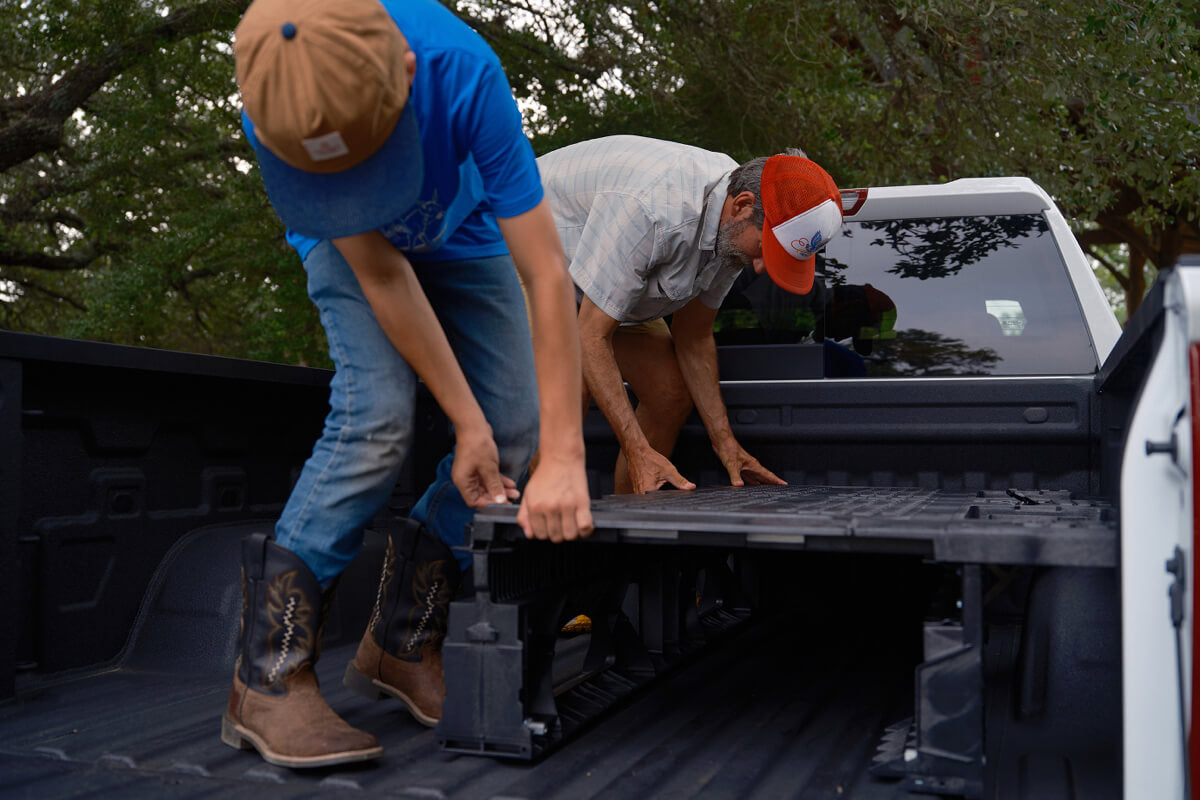Father and son installing a DECKED drawer system together.