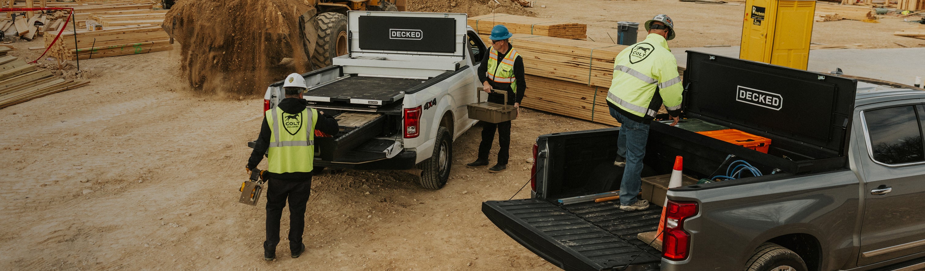 Construction workers accessing tools from DECKED Tool Boxes and Drawer Systems at a jobsite.