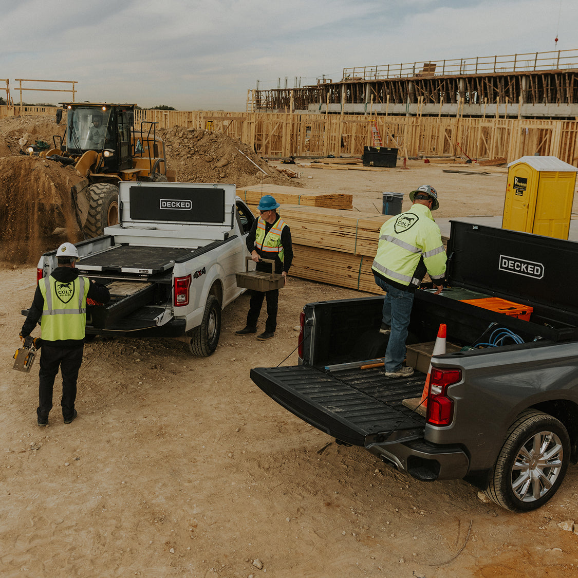 Construction workers accessing tools from DECKED Tool Boxes and Drawer Systems at a jobsite.