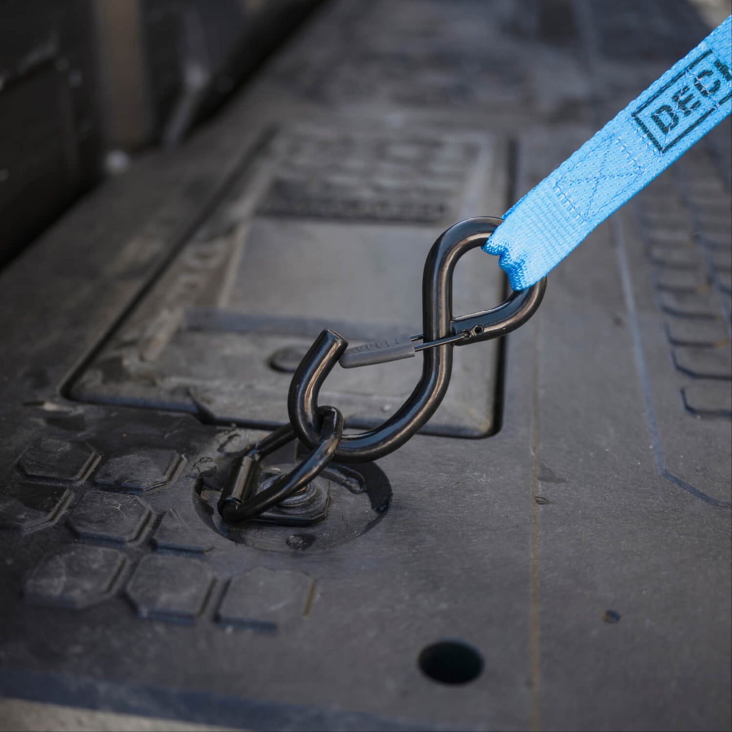 A ratchet strap attached to one of the Drawer System's D-ring Tie Downs.