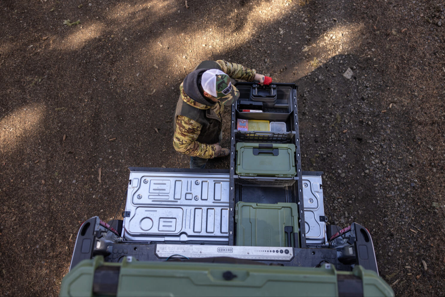 A bird's eye view of a man retrieving gear out of his Drawer System for 8ft trucks.