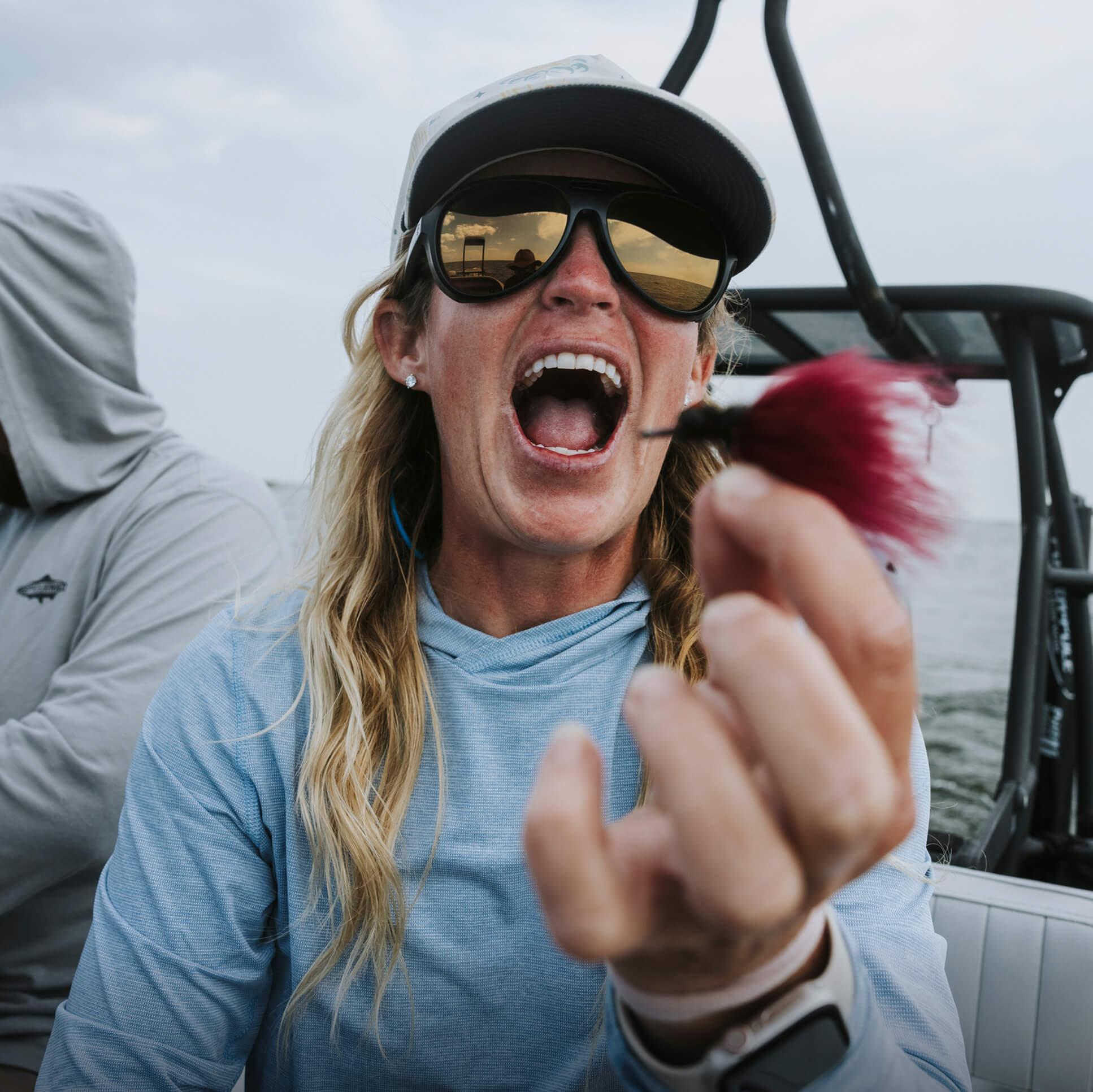 If you could hear this photo, you’d hear Lacey Kelly demonstrating her trademark laugh as she shows off her fly-tying skills.