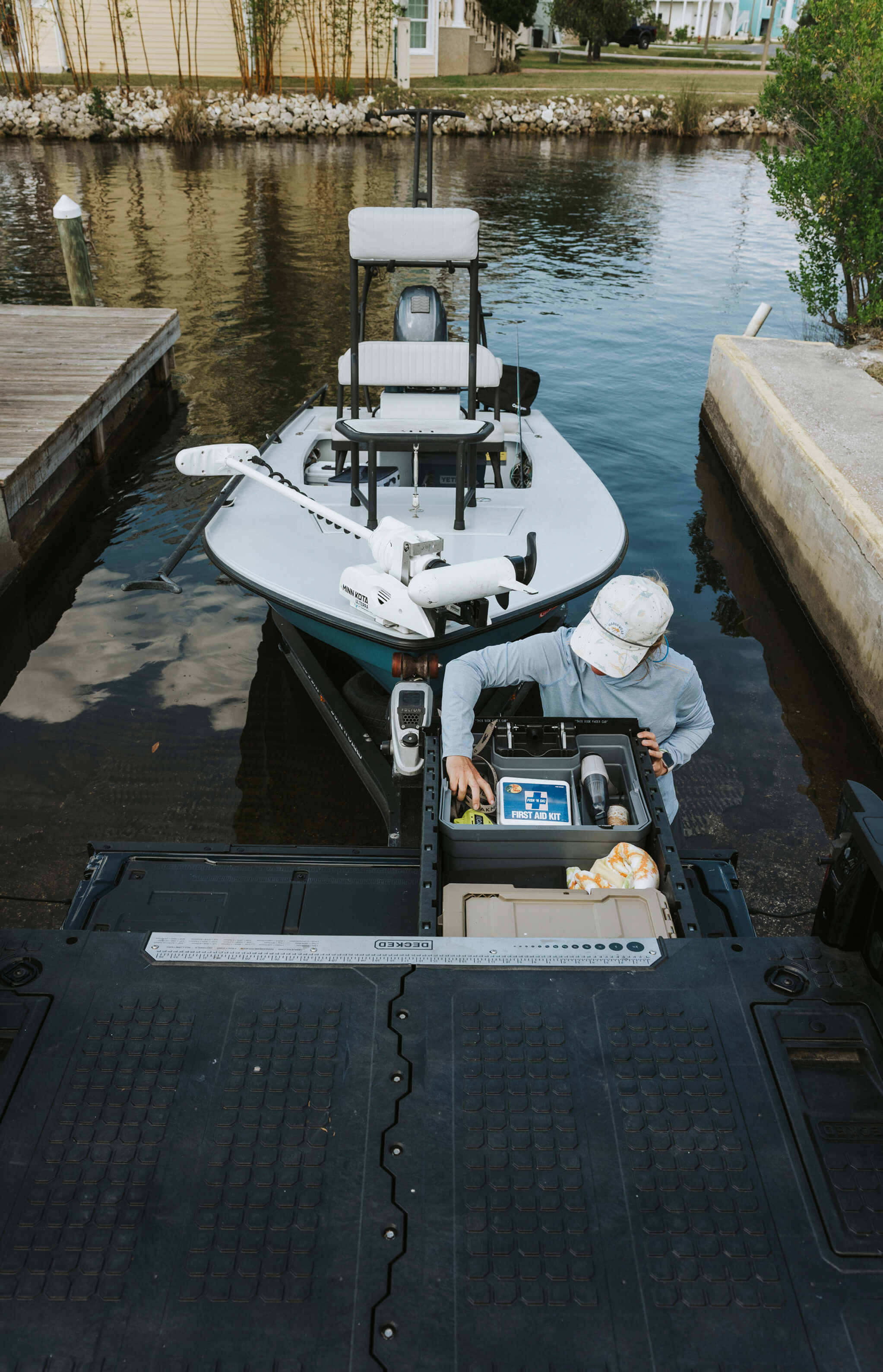 Here we see the fishing guide in her natural environment: Loading gear from a truck to a boat. And how about those DECKED products? Almost like we planned it, eh?