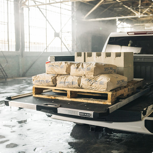 DECKED Cargoglide loaded with cinder blocks and concrete mix in a warehouse.