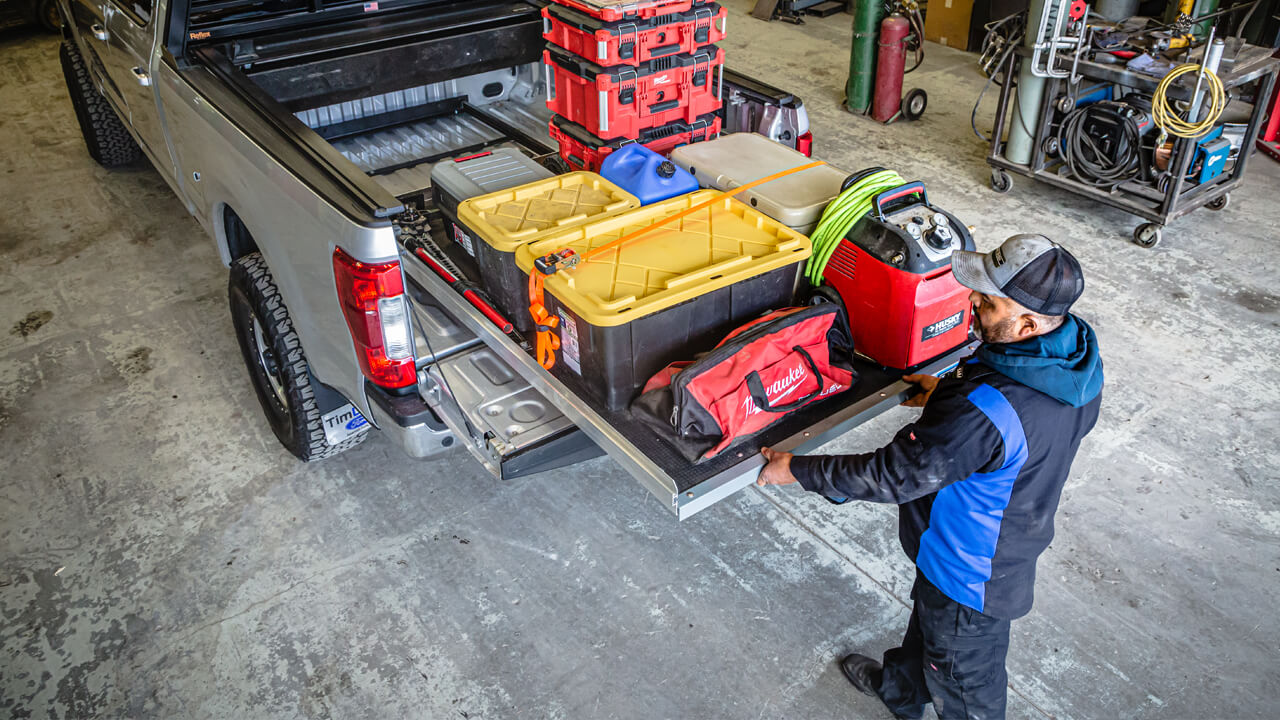 Man pulling out a cargoglide loaded with tools and gear