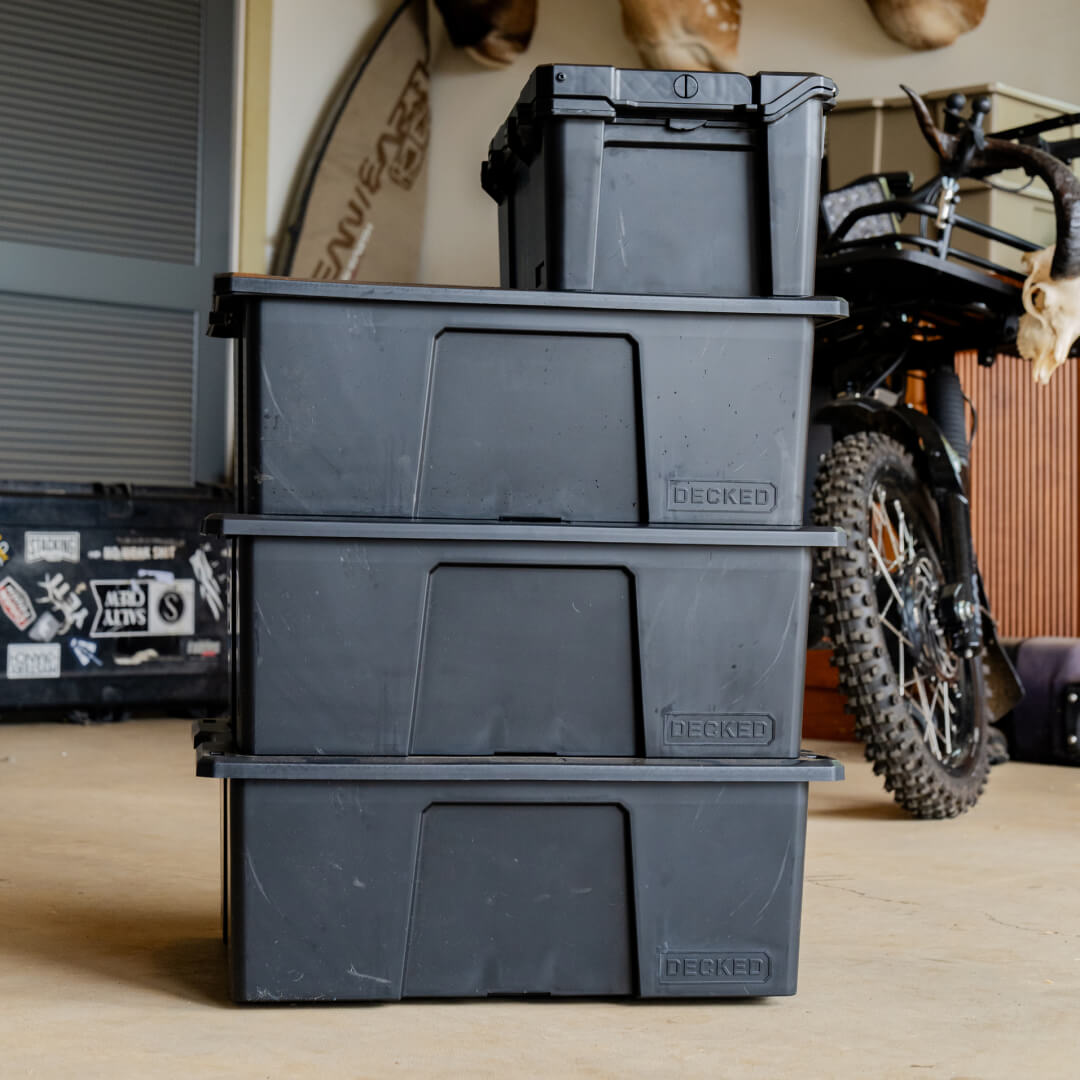 A stack of 3 black Payloader in a garage