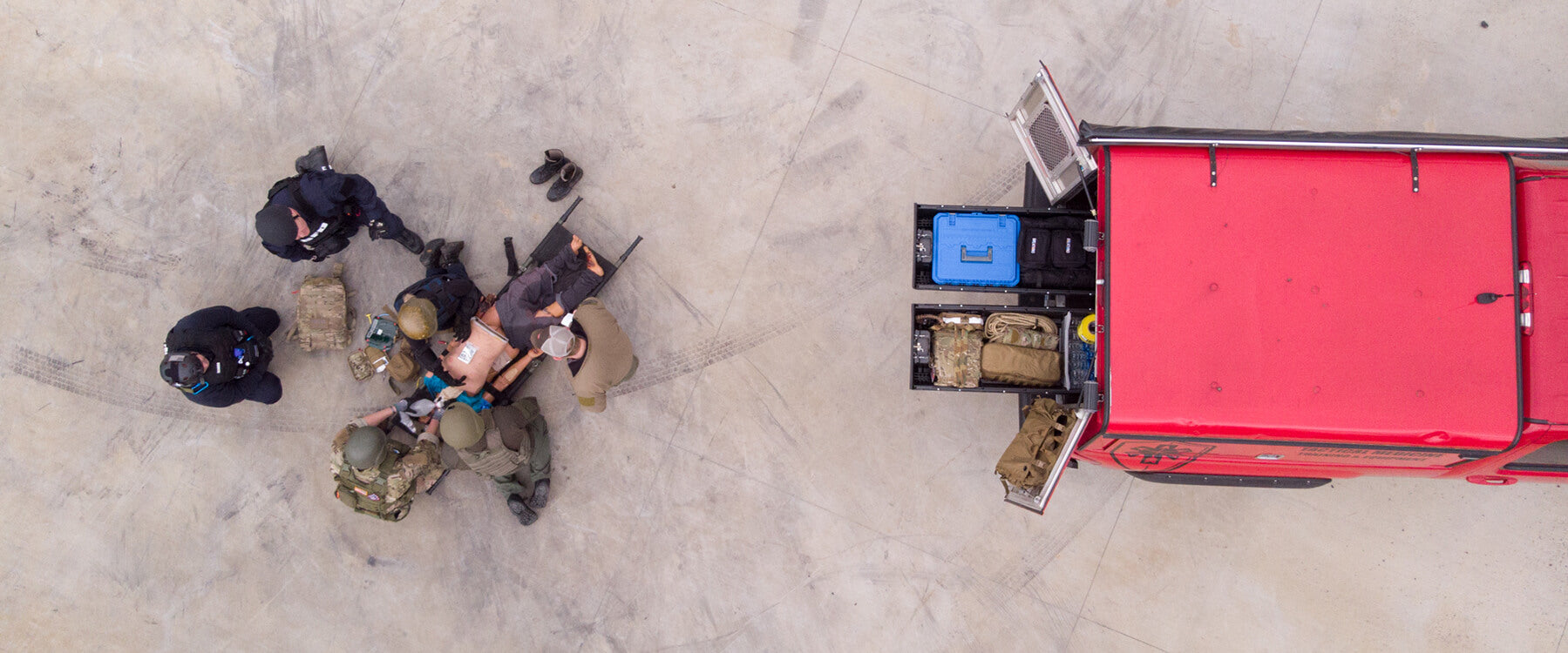 overhead view of a paramedic team doing training with their gear in the back of a drawer system