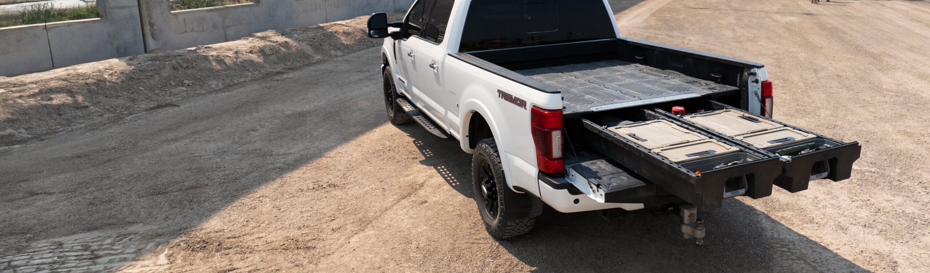 A full-size truck with an open Drawer System in the bed.