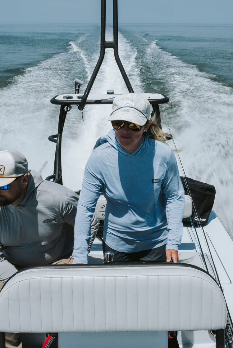 Lacey Kelly deftly piloting her flat-bottom skiff across the shallow waters of Florida’s Nature Coast, on the hunt for big-ol fish.