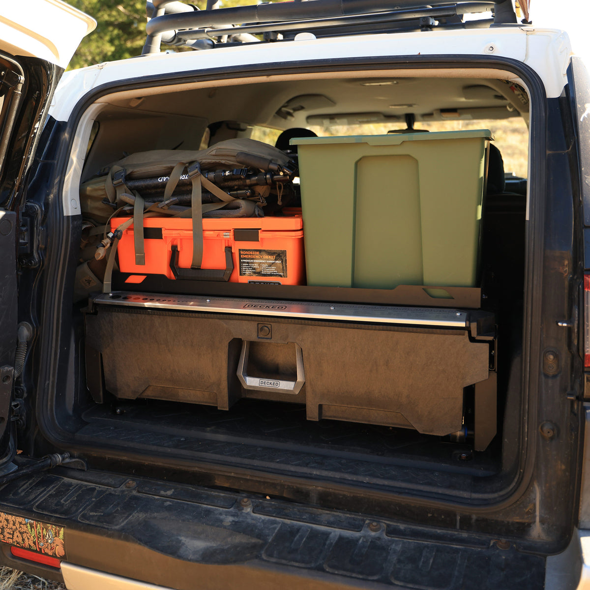 DECKED Drawer System in a Toyota FJ Cruiser with storage cases and gear stacked above it.