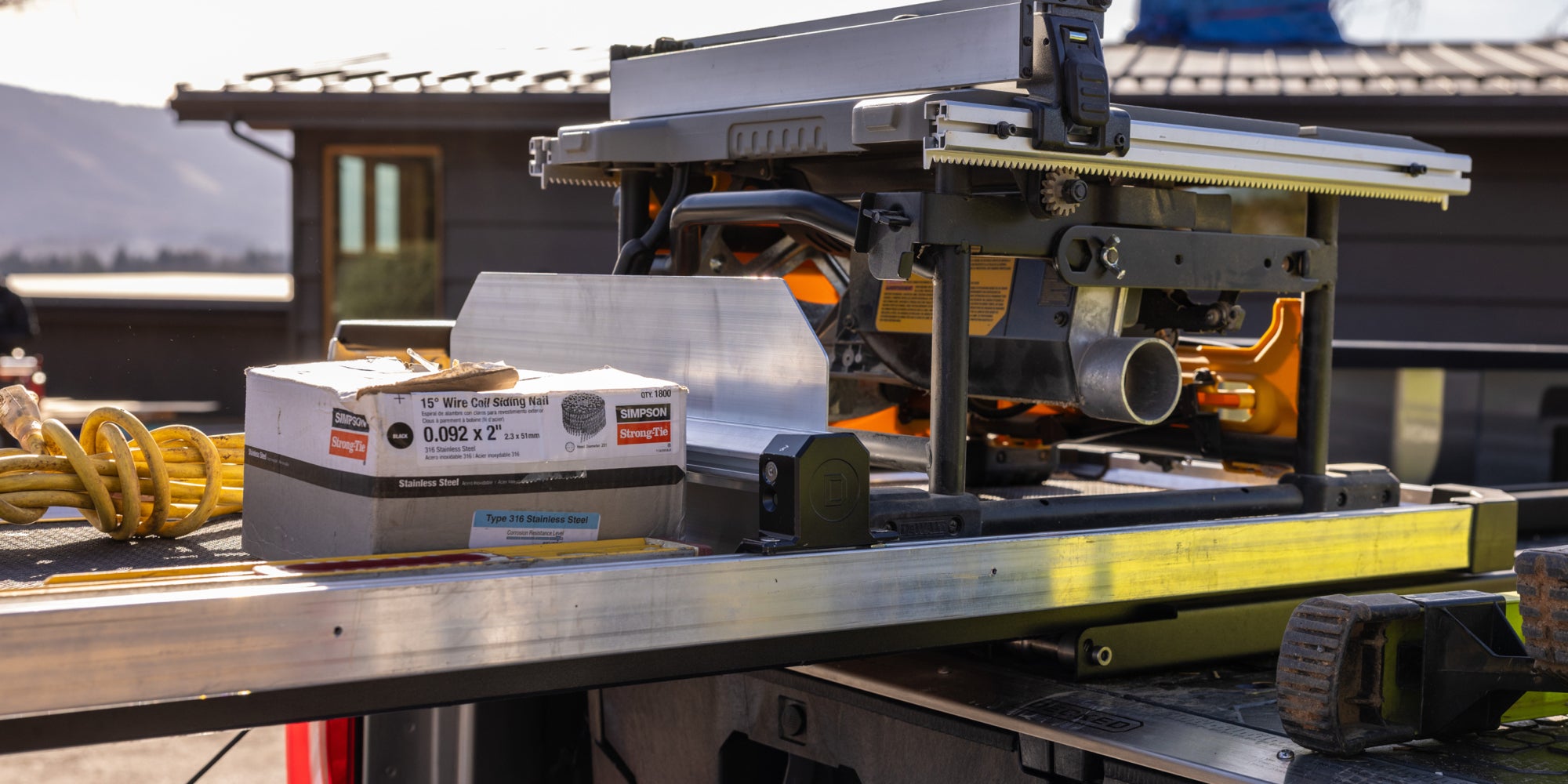 A CargoGlide 600 that is loaded up with construction gear. This gear is secured in place by a Crossbar and accompanying Divider that divides the CargoGlide tray into well-organized sections.