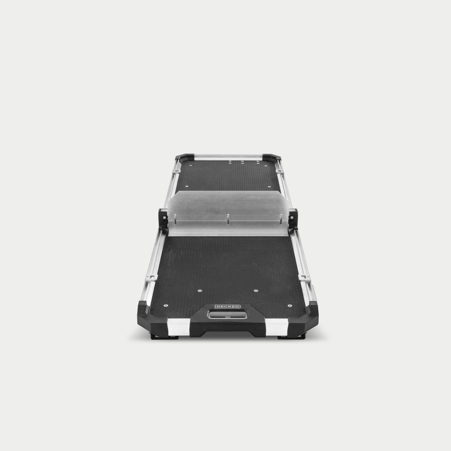 A Crossbar and accompanying Divider mounted to the CargoGlide 600. The Crossbar and Divider are mounted to the side rails alongside some D-ring tie downs. Both accessories can be mounted anywhere along the length of the CargoGlide. The Divider adds height to your modular storage on the tray.