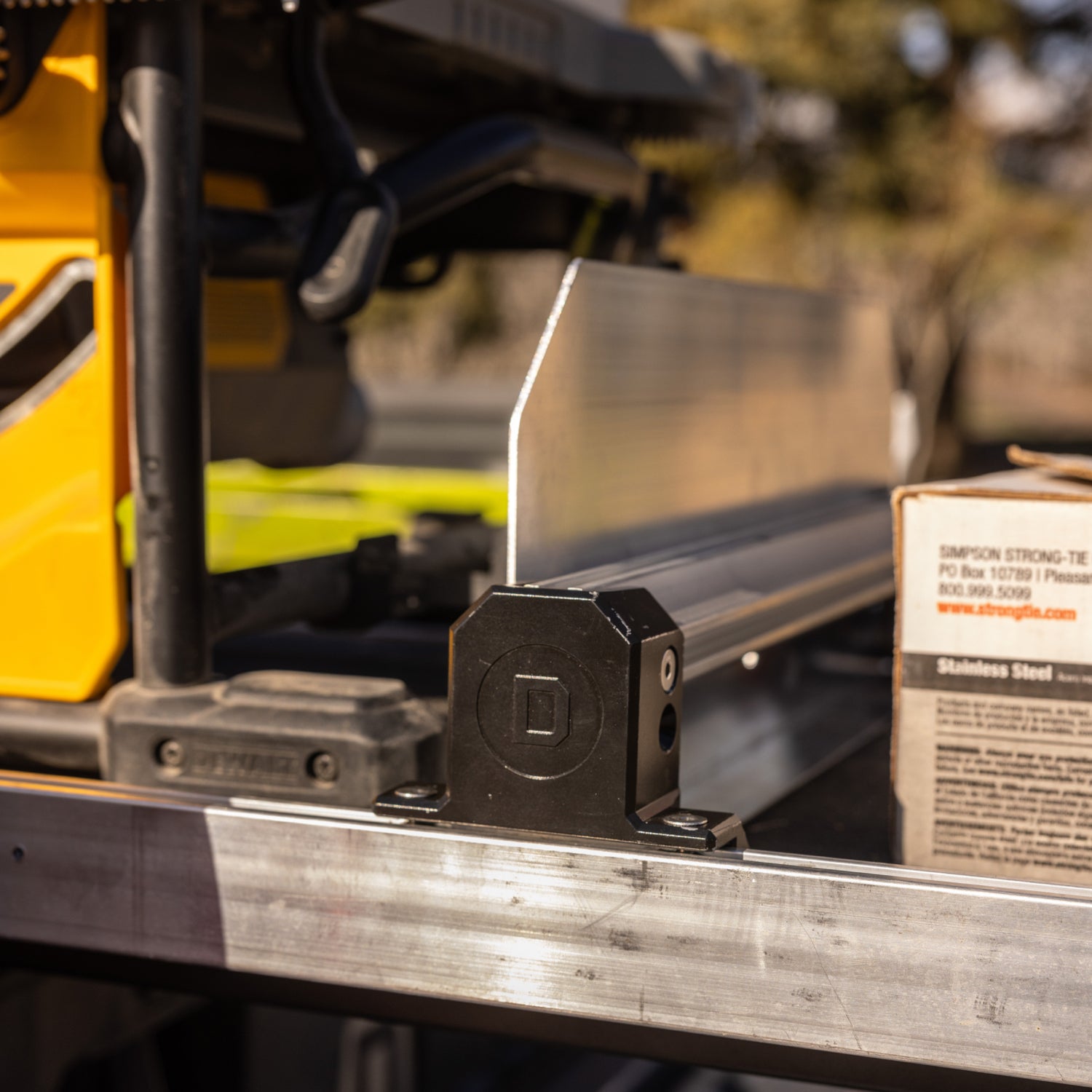 A close up of the mounting point of a Crossbar to the side rail of the CargoGlide.