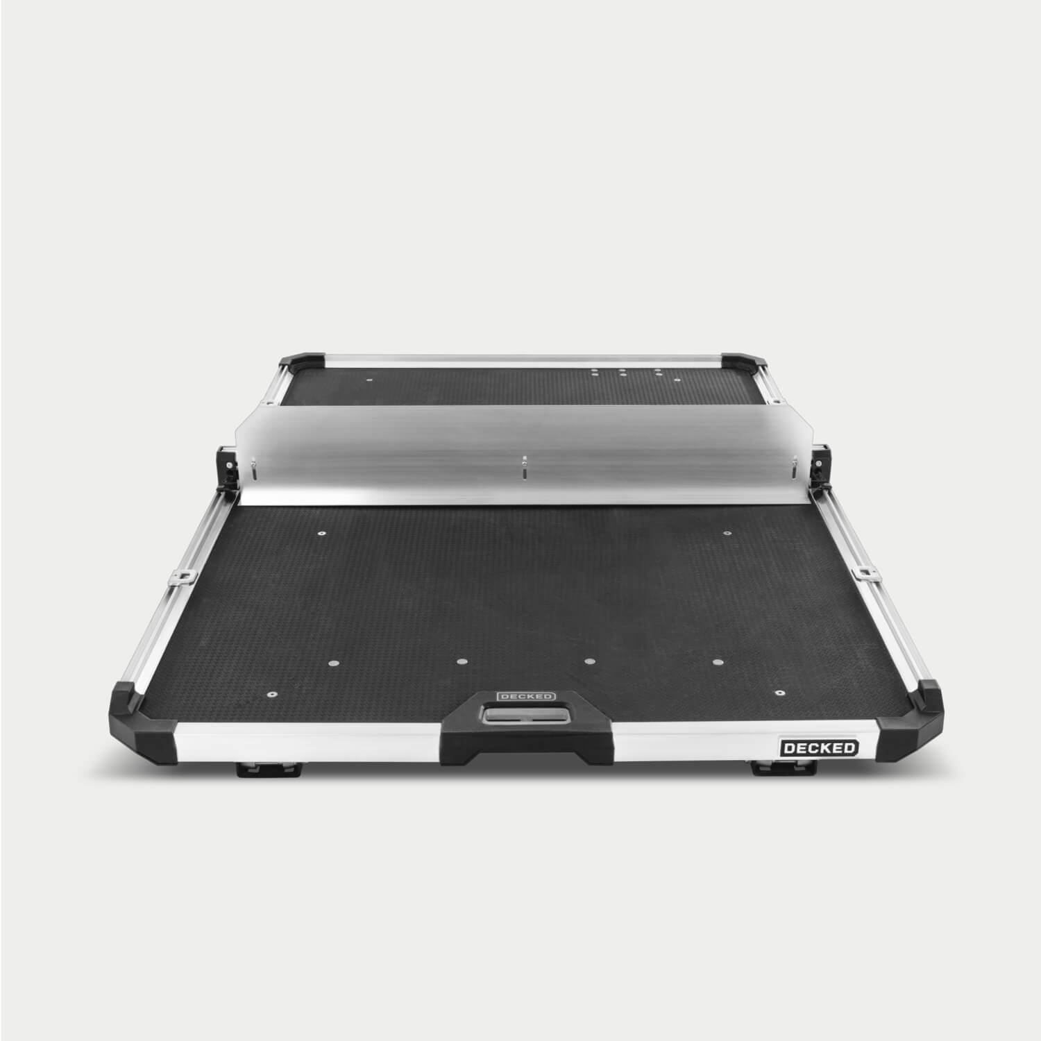 A Crossbar and accompanying Divider mounted to the CargoGlide. The Crossbar and Divider are mounted to the side rails alongside some D-ring tie downs. Both accessories can be mounted anywhere along the length of the CargoGlide. The Divider adds height to your modular storage on the tray.