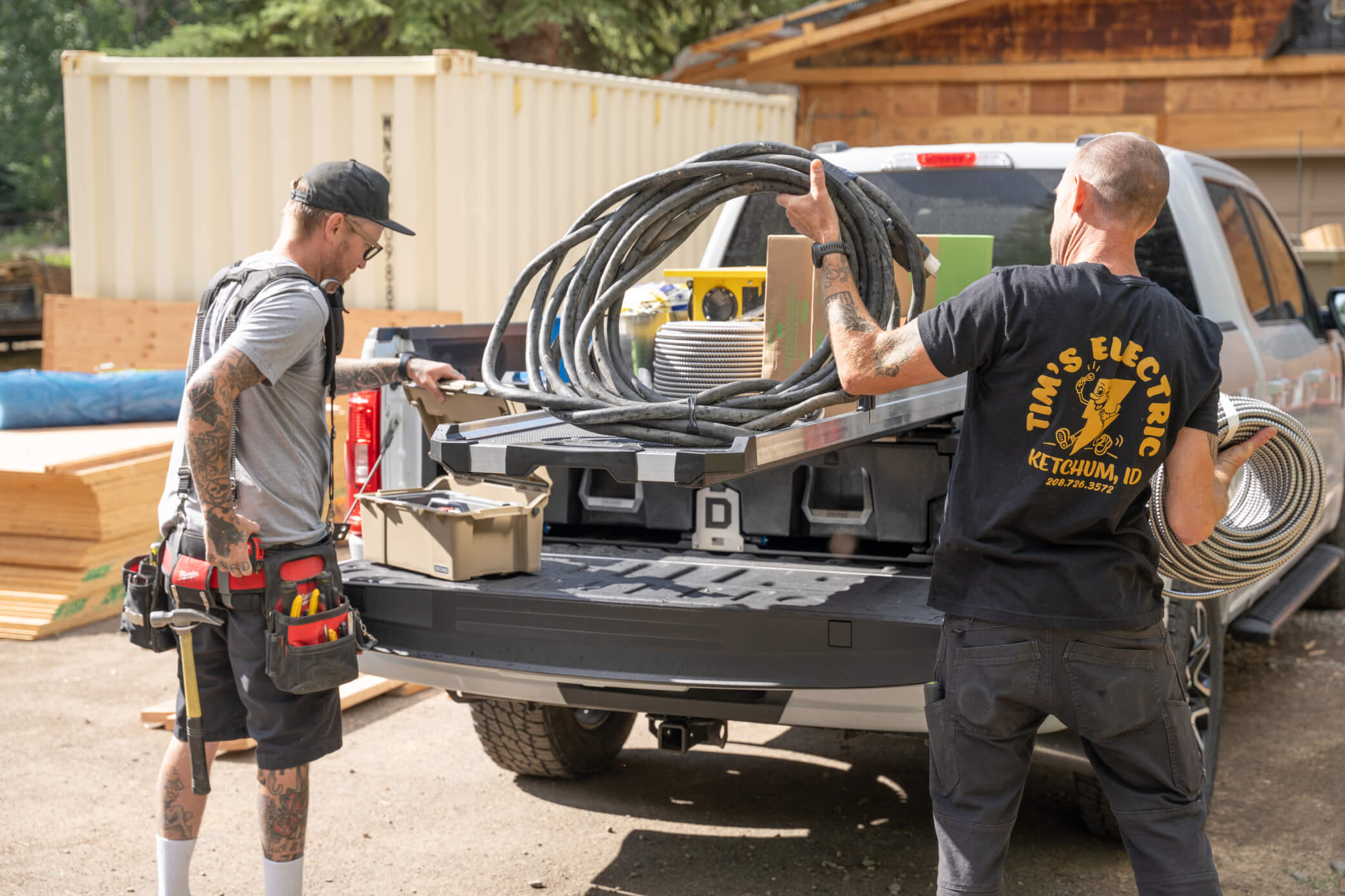 Two electricians retrieving tools from dual-mounted CargoGlides for Drawer System.