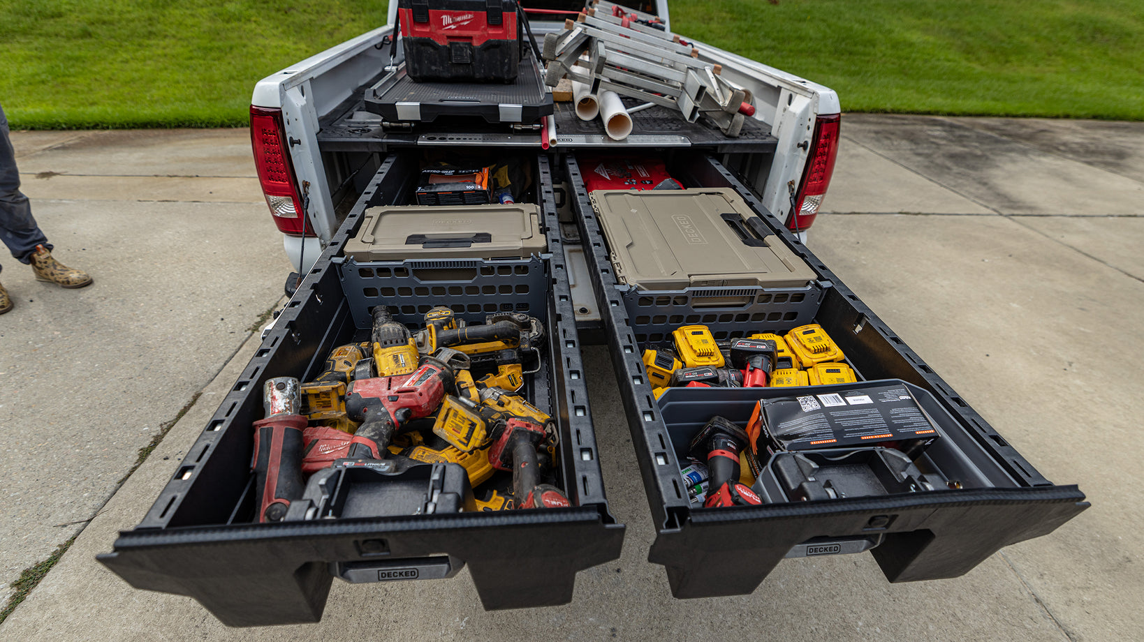 Power tools, batteries, and DECKED D-co Cases organized inside open Drawer System drawers.