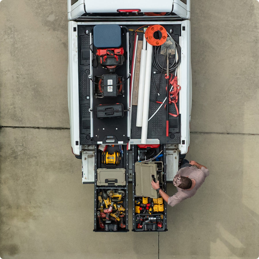 Man opening up DECKED halfrack stored his drawer system with a cargoglide loaded on top.