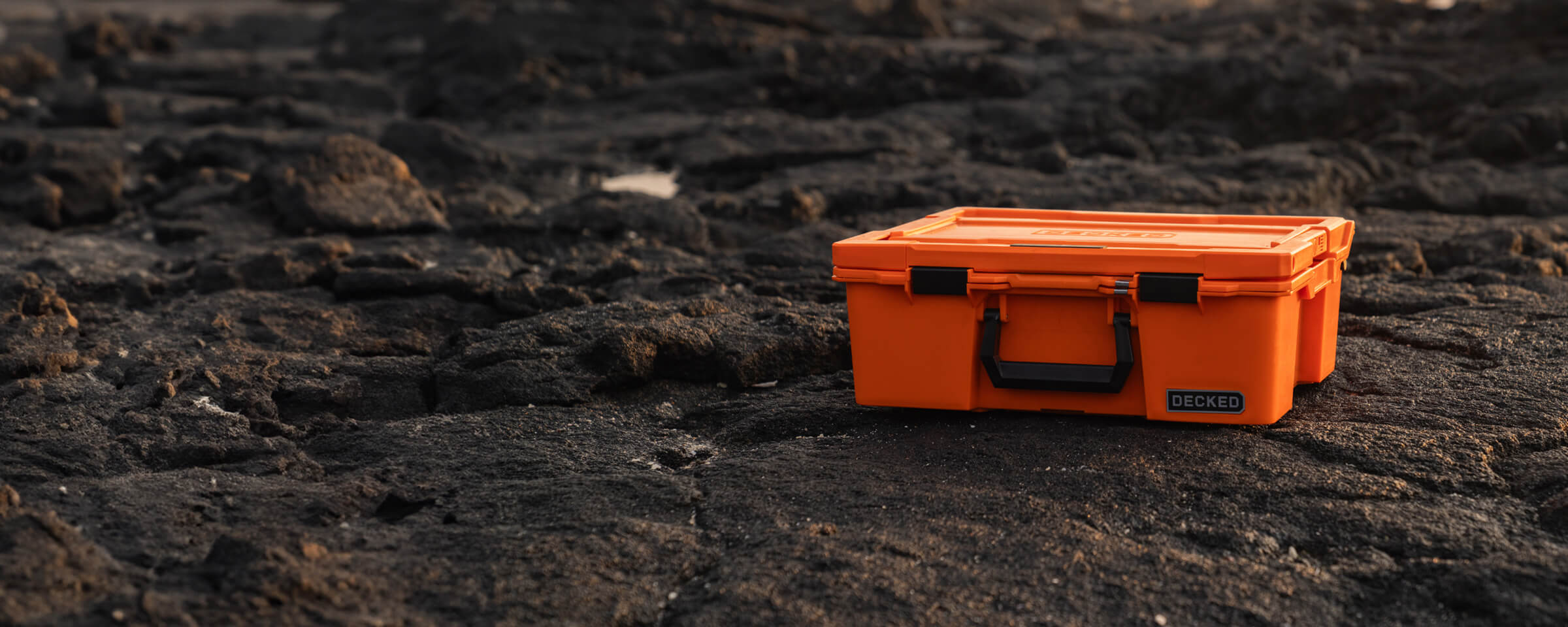 The Blaze Orange Halfrack in stark contrast to the dark lava rock its sitting on.