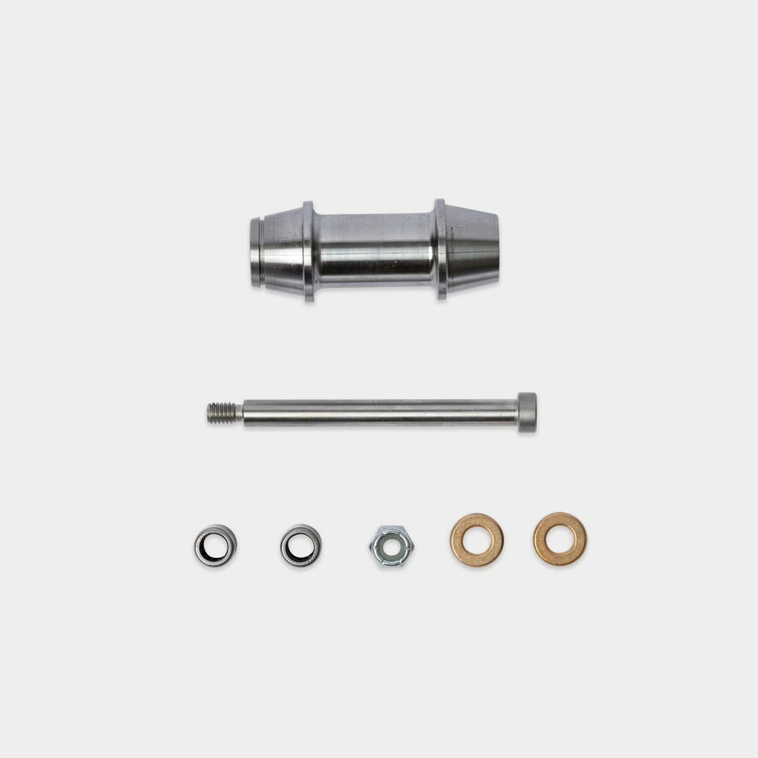 A metal hardware kit containing a cylindrical metal sleeve, a threaded metal rod, a silver hex nut, and two flat washers in silver and bronze, arranged on a light gray background.