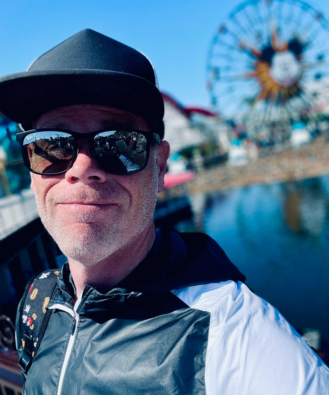 Andrew smiling in front of the Disney carousel.