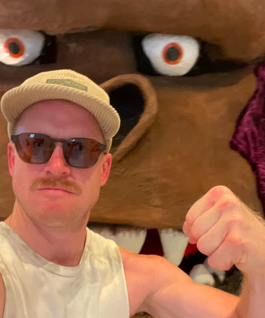 Beni flexing in front of a cartoon gorilla.