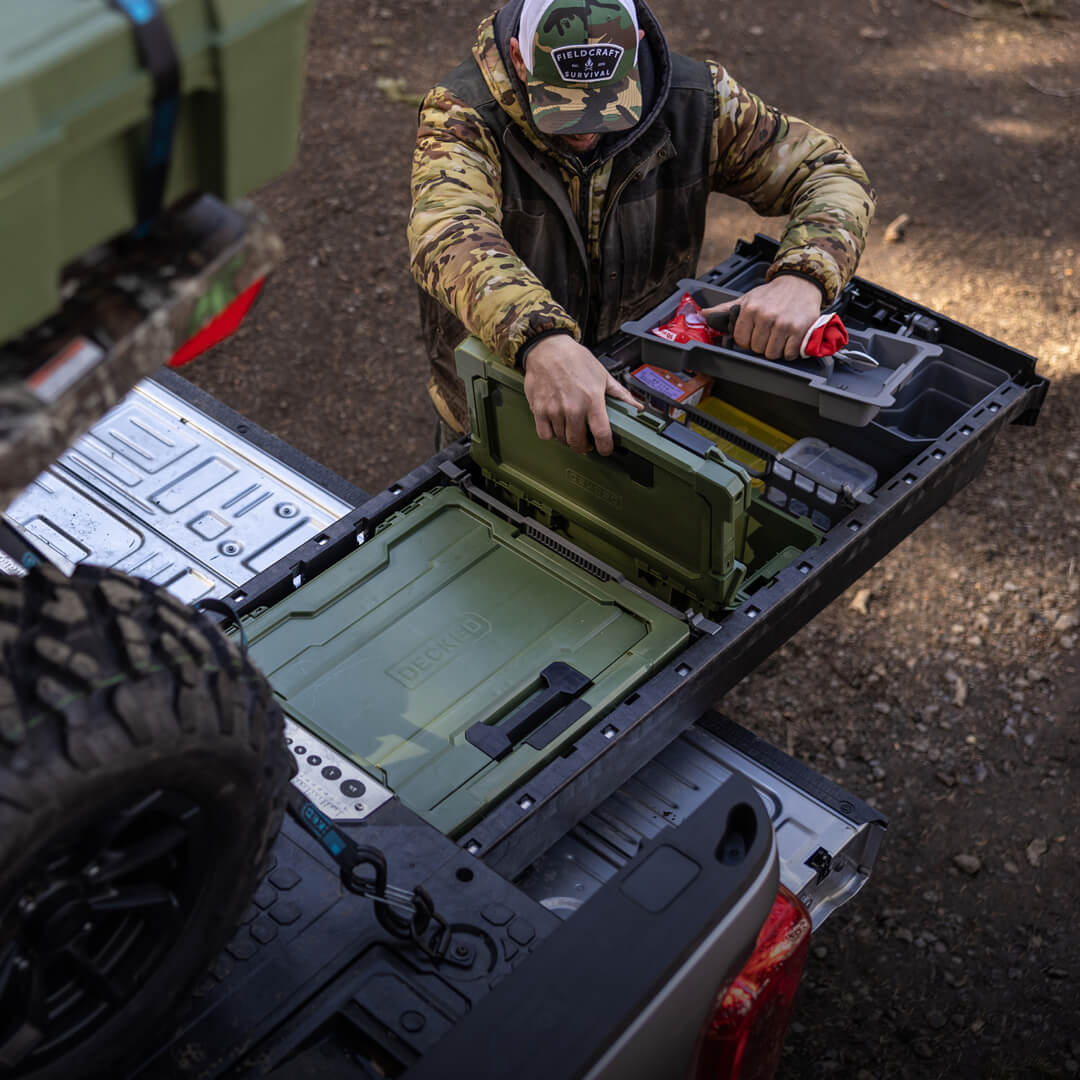 A man retrieving a Cargo Tray out of the Sixer D-co Case stored securely and neatly inside of his Drawer System.