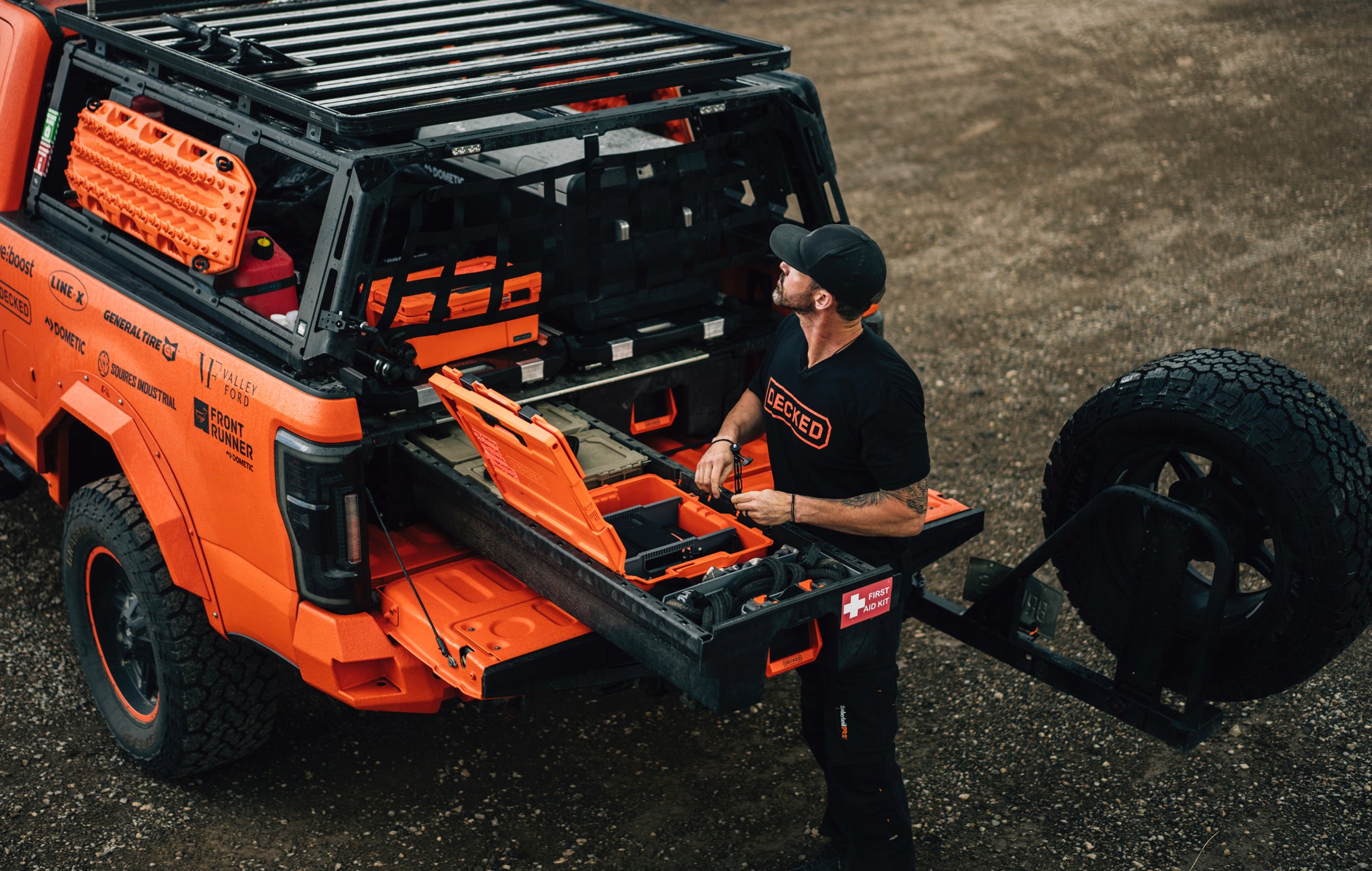 Brutus, the orange off-road vehicle with Drawer System open and Ricky Forbes standing next to it.