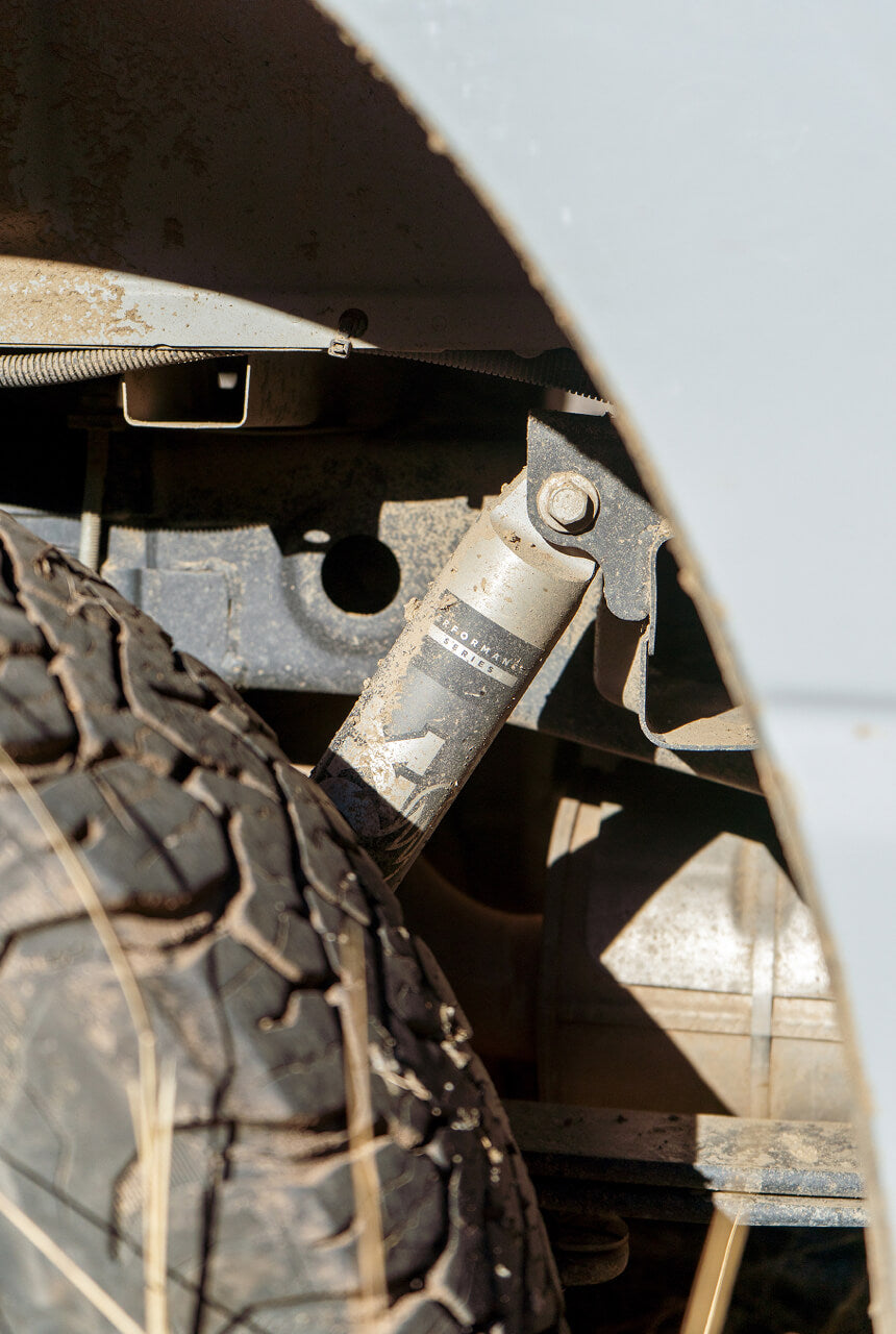 Close-up of a vehicle's suspension system with a tire in the foreground
