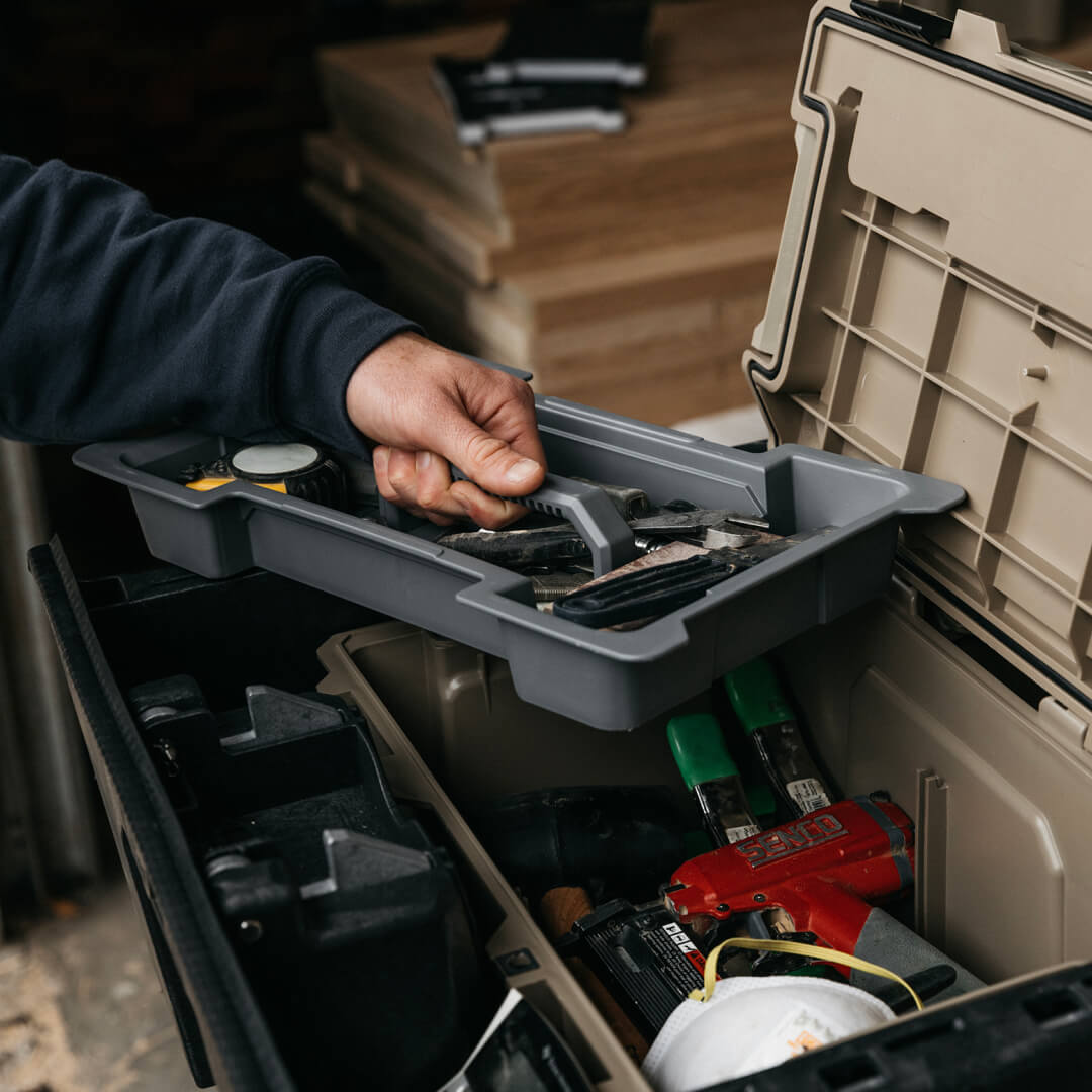 Man pulling a D-co Case cargo tray full of tools out of his Sixer