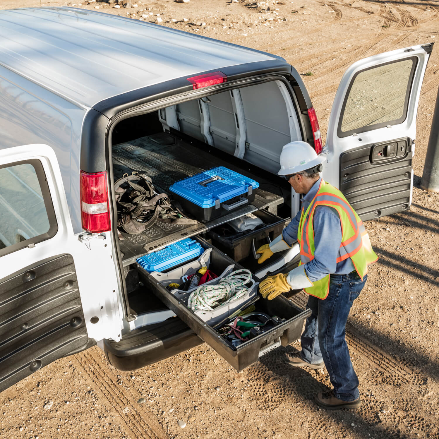 Construction worker accessing his tools in the back of a cargo van