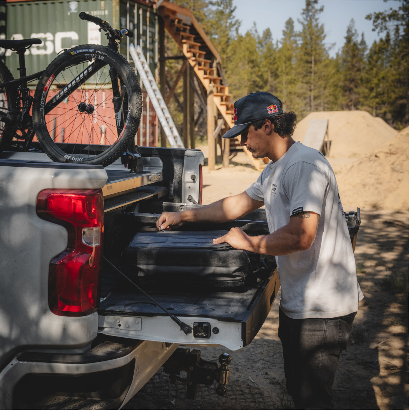 Carson Storch opening up his DECKED D-bag backpack on his truck's tailgate.