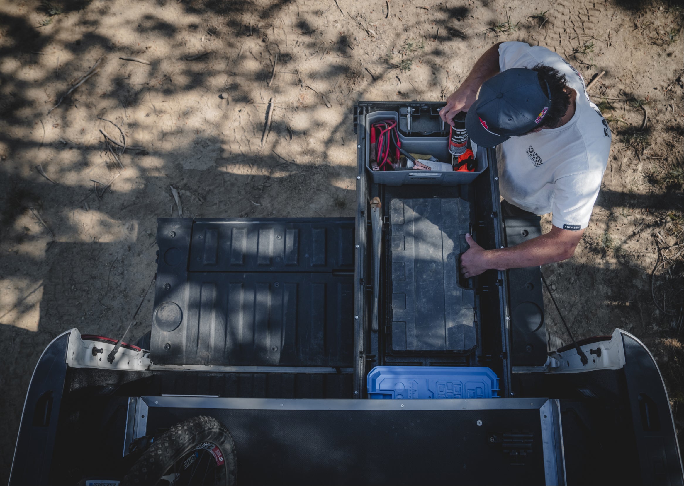 Carson Storch pulling bike gear out of his DECKED Drawer System.