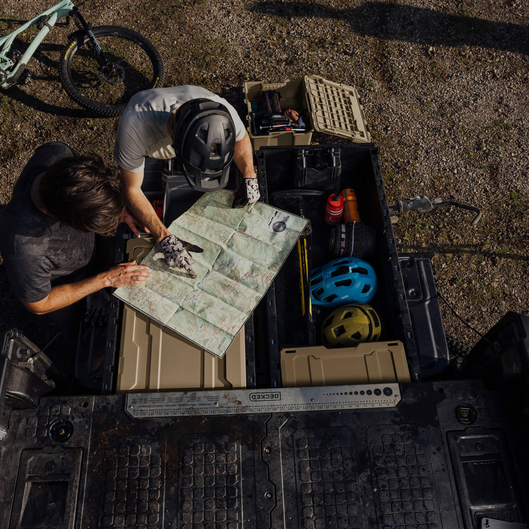 Person pointing to a location on a map planning a mountain bike ride