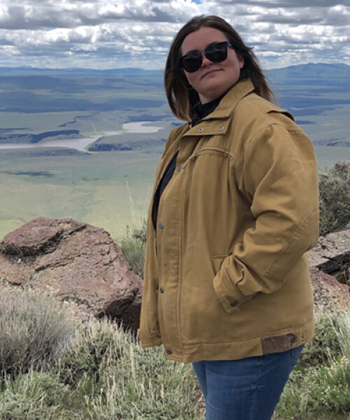 Woman posing on a mountaintop