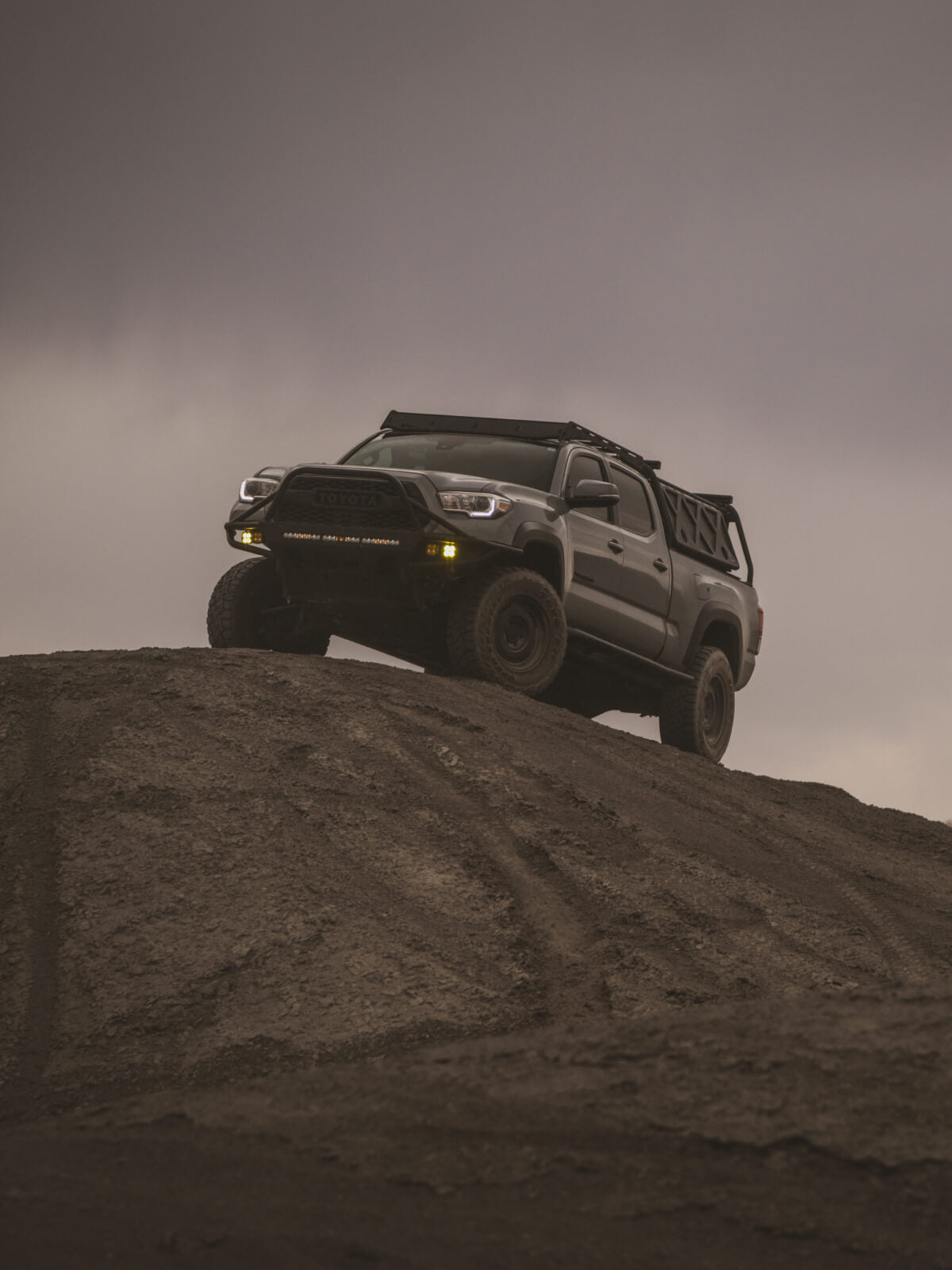 truck driving up a hill in the desert