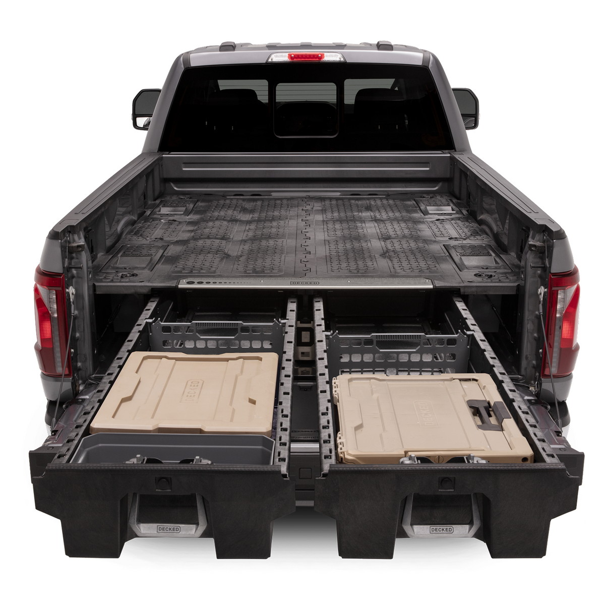An open drawer system with 'DECKED' d-co cases and other storage options in the bed of a Ford F-150.