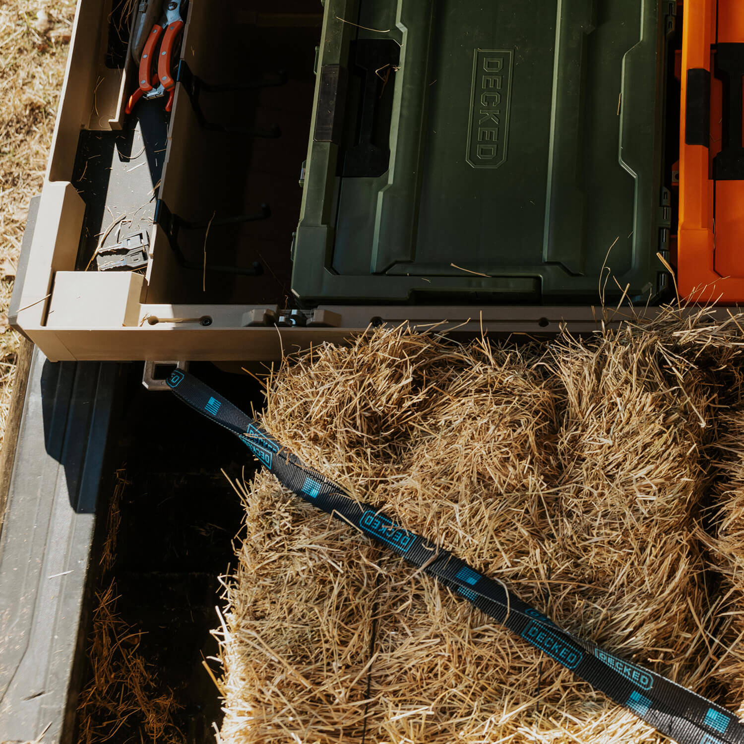 D-ring tie-downs securing hay and other items in the bed of a truck.