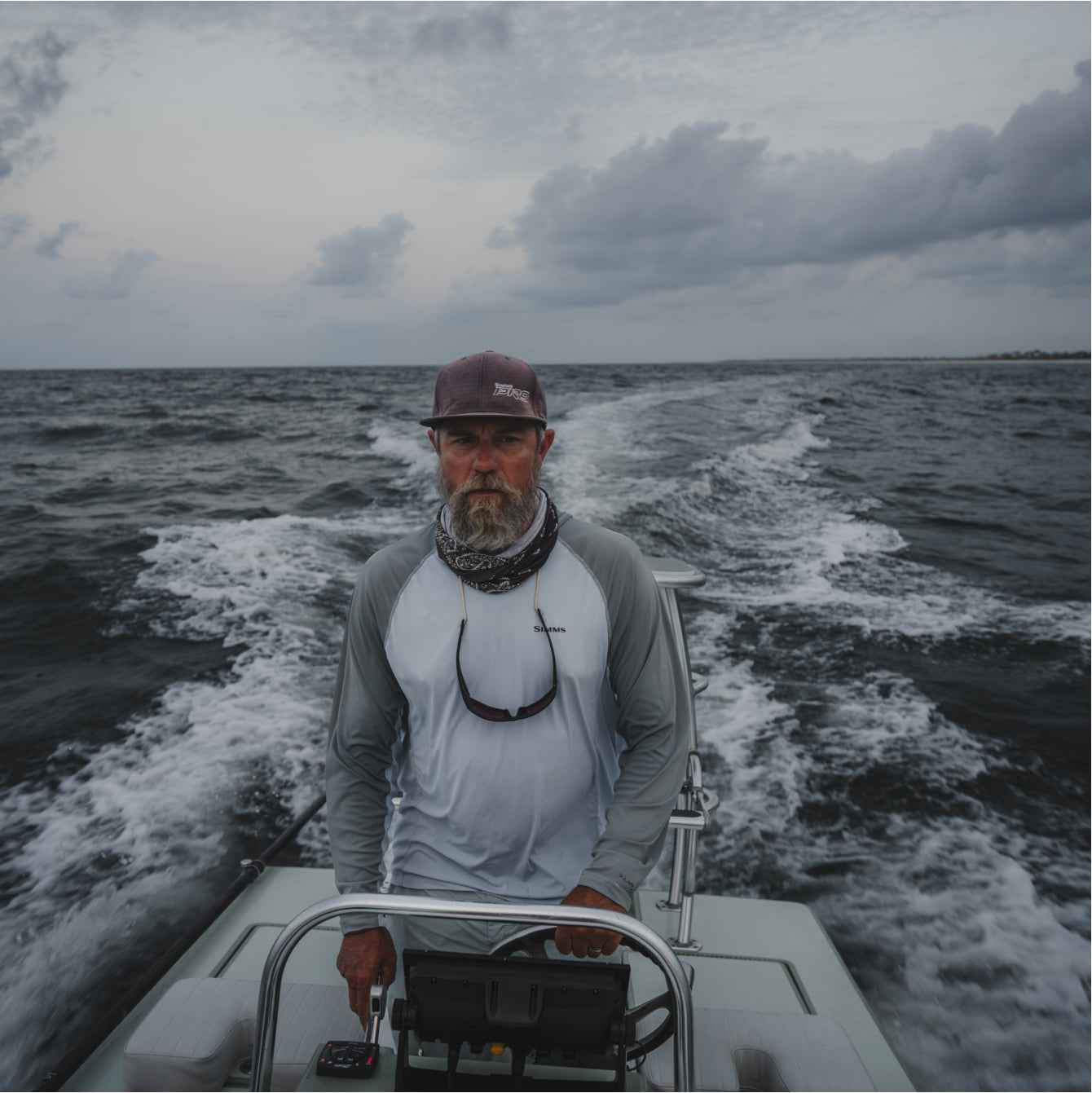 David Mangum at the helm of his boat in choppy water.