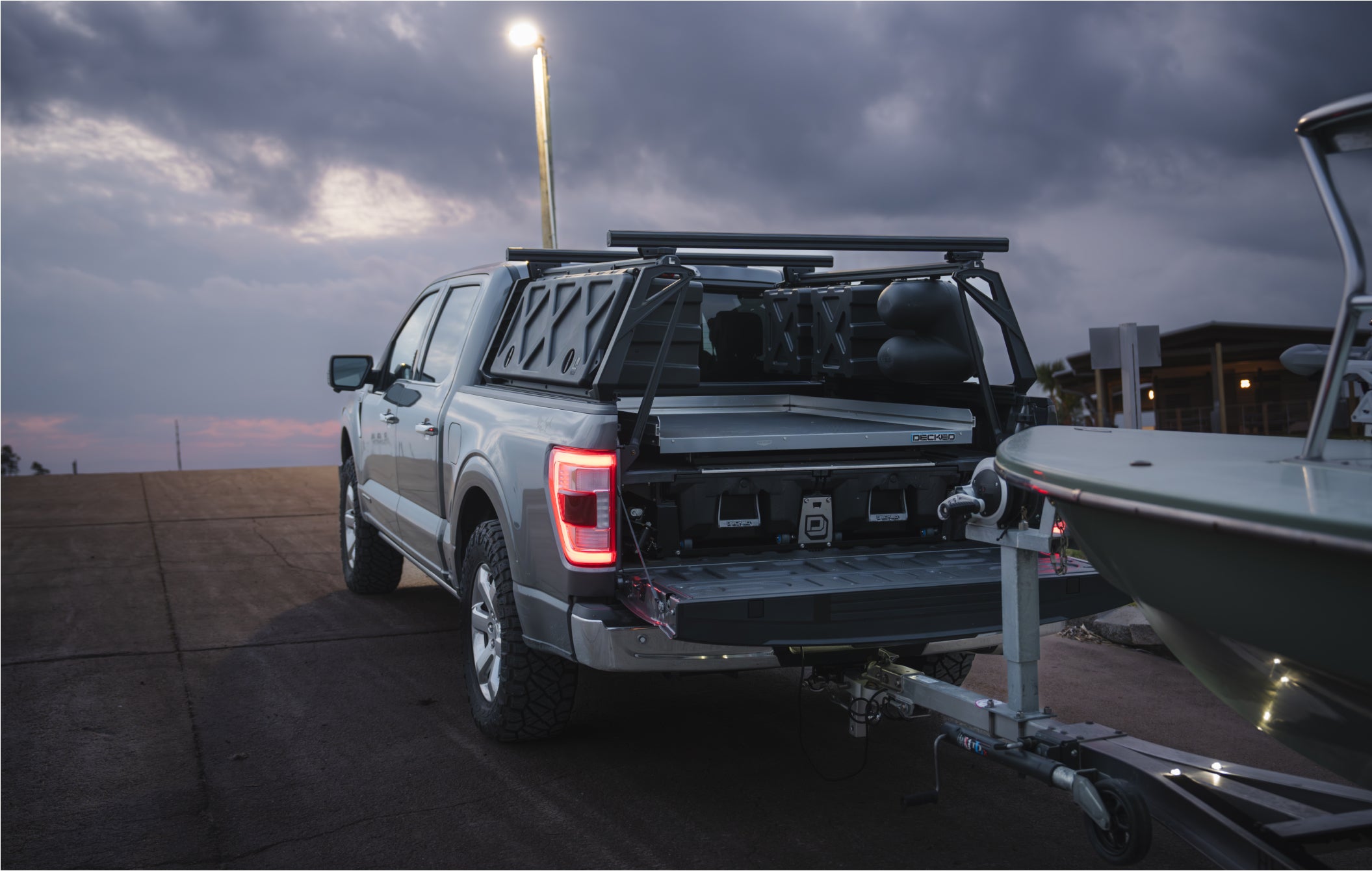 David Mangum's truck, towing his boat and sporting a DECKED Drawer System and CargoGlide.