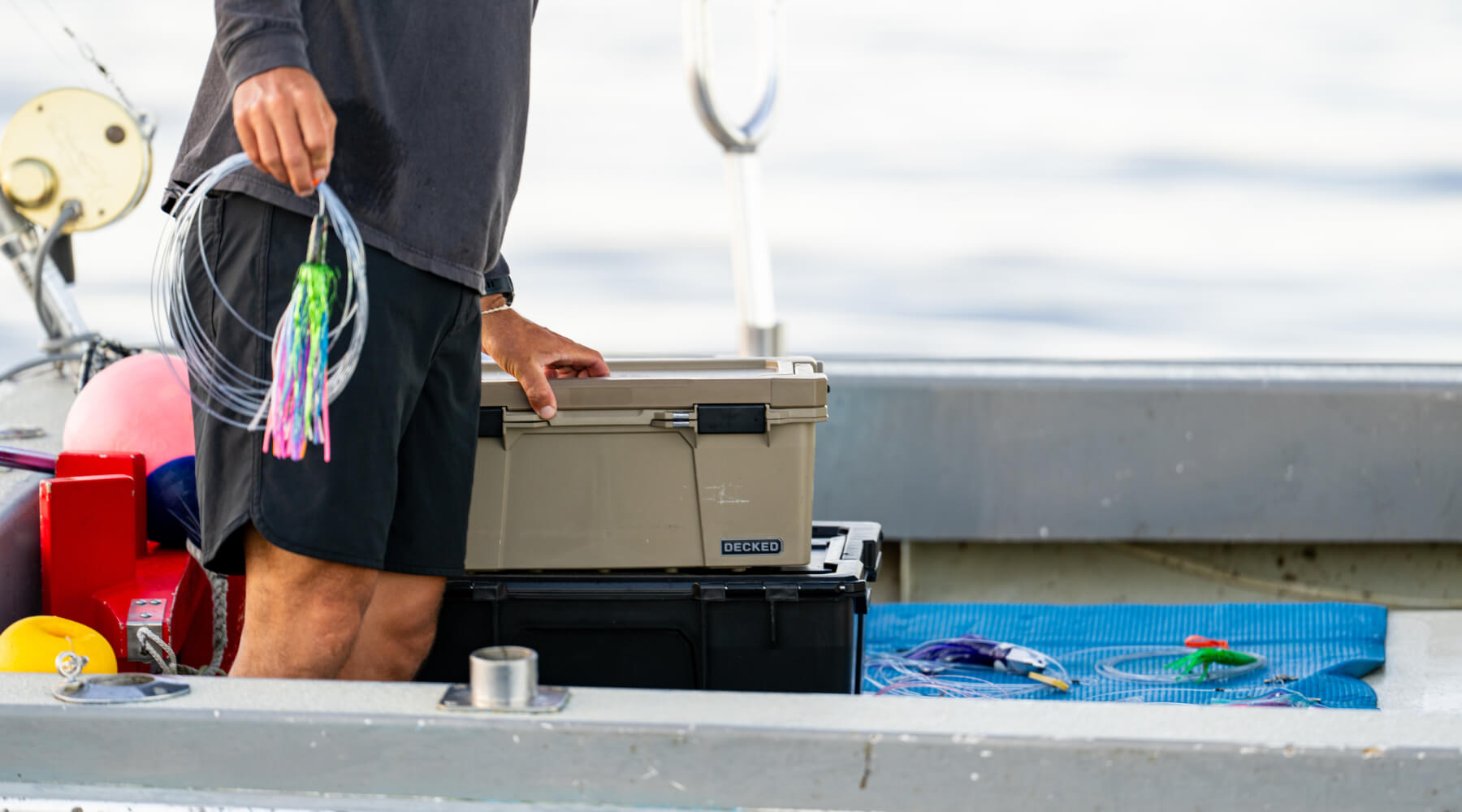 A man stowing a neatly coiled fishing lure into his Halfrack D-co Case.