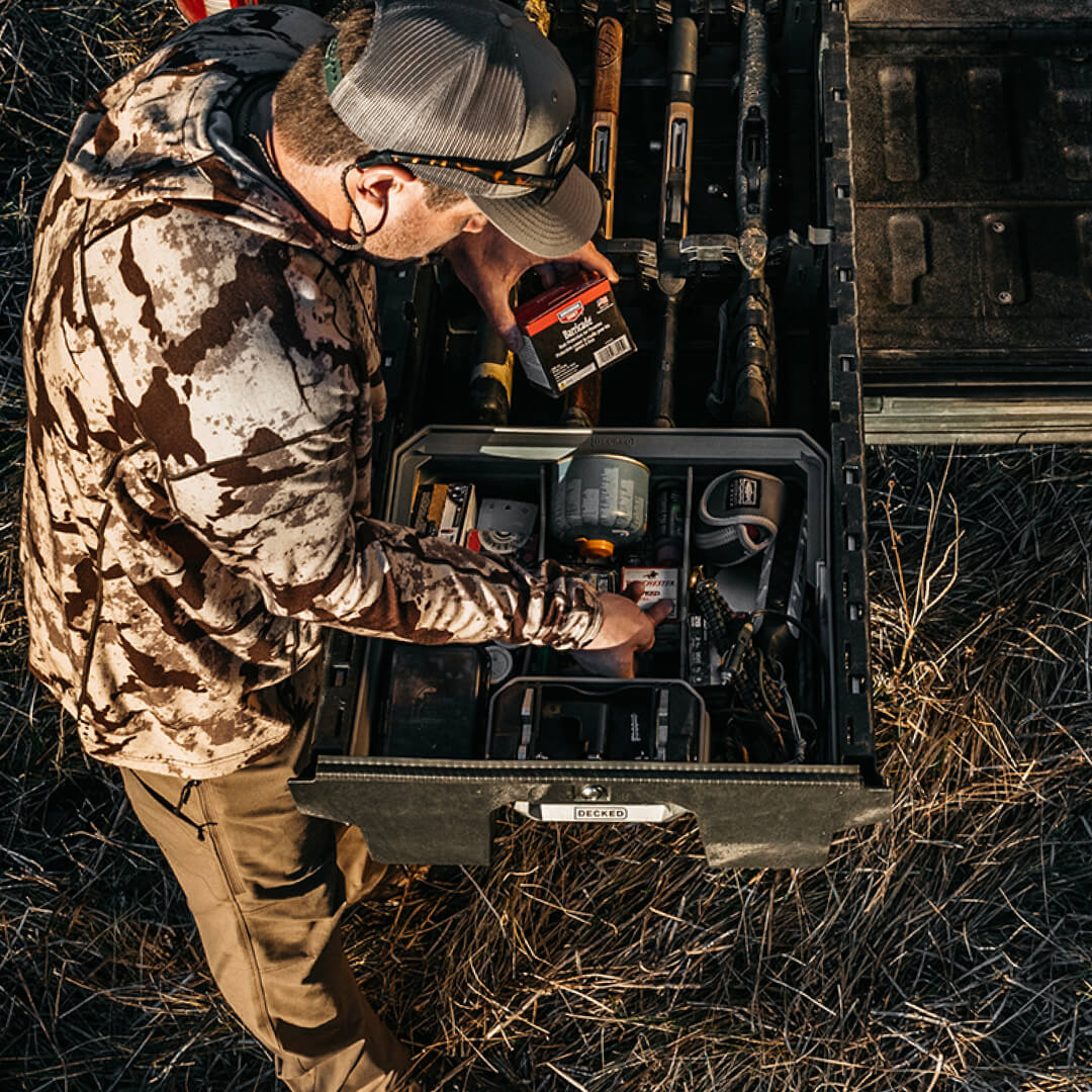 Hunter reaching for his ammo stored in a double drawerganizer