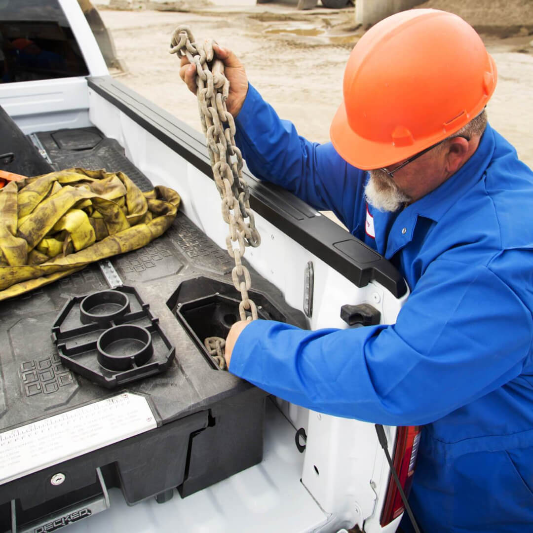 Construction worker grabbing chains out of the Ammo Cans on a Drawer System