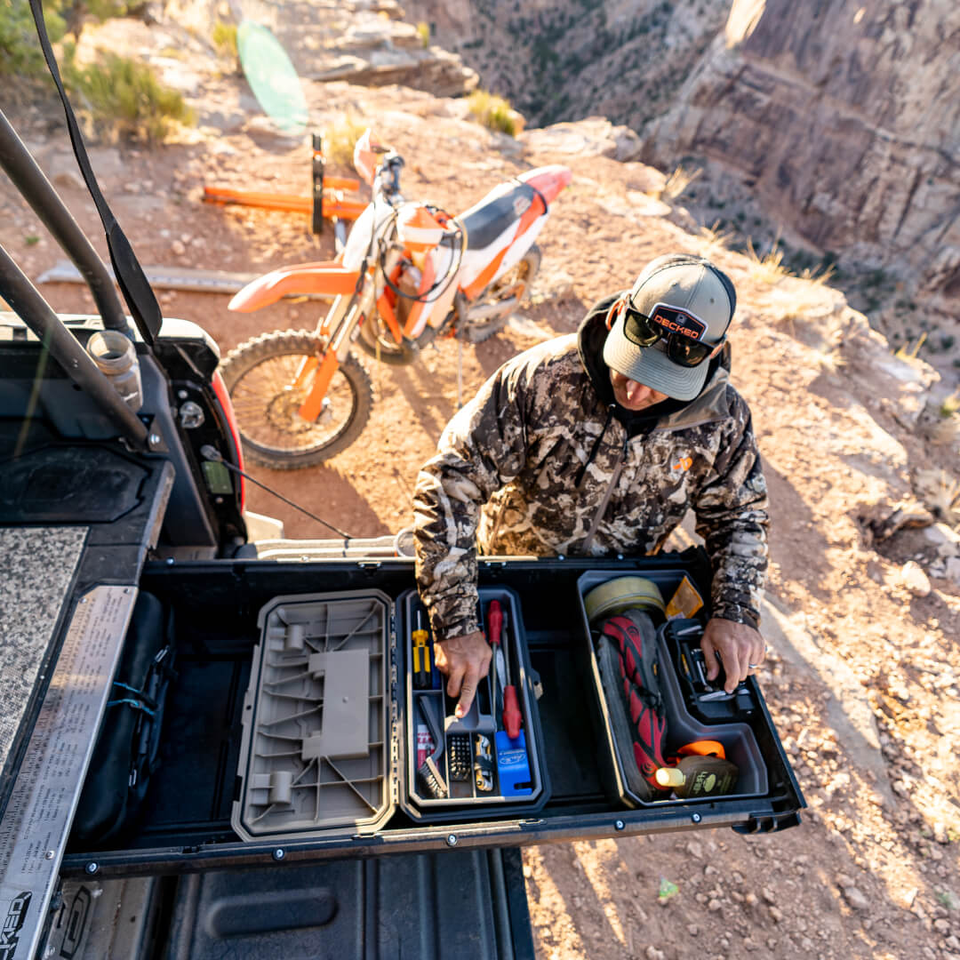 Overhead view of an open drawer with dirt bike gear