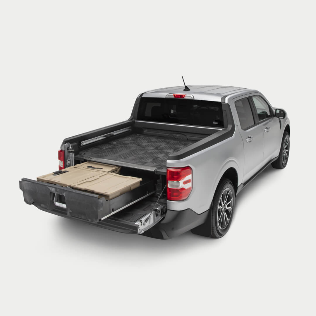 Side angle view of a Drawer System installed in a Maverick with the drawer open and one Sixer and two Halfracks inside.