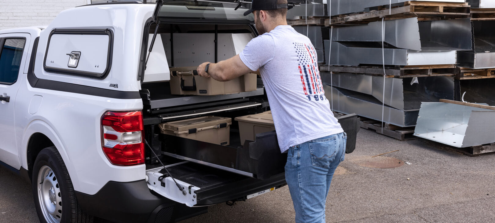 A man putting a Halfrack on top of a Maverick Drawer System with CargoGlide