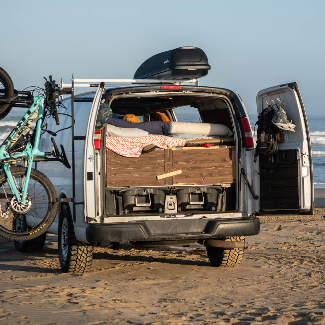 Drawer System installed in a cargo van being used for camping on a beach